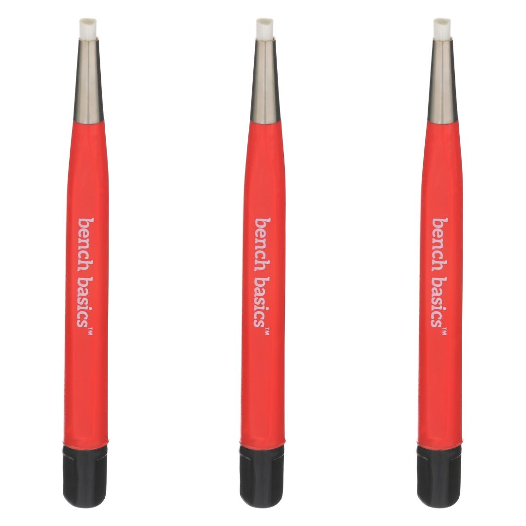 A close-up photo of three Bench Basics Fiberglass Bristle Brushes, each with a long handle and a circular brush head made of white fiberglass bristles. The brushes are housed in a clear plastic packaging with a red and white label, and the package is set against a white background